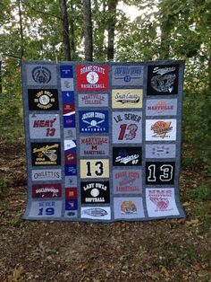 a quilt made to look like the baseball team's jersey is displayed in front of some trees