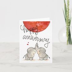 an anniversary card with two elephants holding each other's trunk