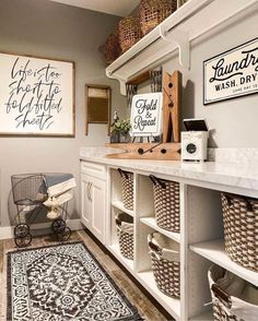 a laundry room with white cabinets and baskets on the shelves, along with rugs