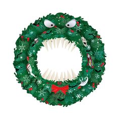 a christmas wreath with eyes and teeth on it