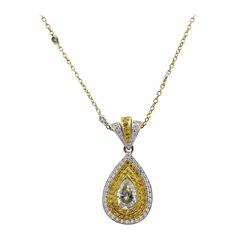 Natural Fancy Yellow Diamond 18 Karat Drop Necklace In Stock This exquisite natural fancy yellow diamond drop necklace in 18-karat gold features natural yellow diamonds that exude elegance. A stunning statement piece, perfect for elevating any outfit with timeless sophistication. Material: 18k Yellow Gold and 18k White Gold Diamond Details: The center stone is a Marquise cut, natural, fancy yellow diamond, weighing approximately 1.20 carats. In addition, there are approximately 0.70 carats of en Luxury Yellow Gold Drop Necklace In Fine Jewelry Style, Luxury Yellow Gold Fine Jewelry Drop Necklace, Luxury Yellow Gold Diamond Necklace With 17 Jewels, Luxury Yellow Gold Pendant Drop Necklace, Luxury Yellow Single Strand Necklace, Champagne Diamond Necklace, Yellow Diamond Necklace, Diamond Drop Necklace, Halo Diamond Earrings