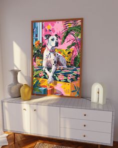 a dog sitting on top of a dresser next to a painting