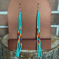 Stunning Three Strand Seed Bead Earrings. Southwestern Pattern Featuring Turquoise With Shades Of Orange, Yellow, And Red. Hook With Backing Design. Brand New. Measurements: 4.5 Inches Long Seed Bead Jewelry Patterns Simple, Western Beaded Earrings, Ojo Bracelets, Native Beaded Earrings, Southwest Pattern, Beaded Jewelry Earrings, Seed Bead Jewelry Patterns, Stick Earrings, Bead Diy