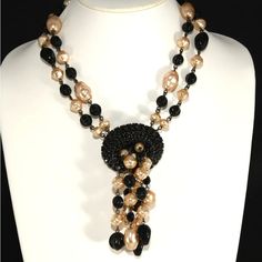 This is part of Chairish’s Costume Jewelry assortment.  Francoise Montague, a company associated with high quality French jewelry for decades, produced this necklace comprised of faux pearls, black glass beads, and chalk black rhinestones. Marked FM Paris and also comes with the original hang tag. The style name on the back of the tag is "Panache." We believe this item dates to the early 2000s. Adjusts from about 16.5 inches to 18.5 inches long; front dangling element measures about 4.25 inches Black Beads Necklace, French Jewelry, Black Bead Necklace, Black Rhinestone, Beads Necklace, Early 2000s, Hang Tags, Black Glass, Black Beads