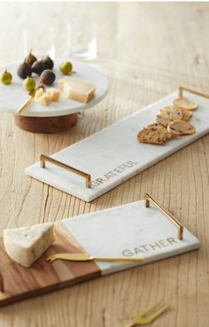 cheese platters with wine and crackers on them