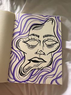 an open book with a drawing of a woman's face in purple and white