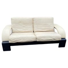 a white couch with black legs on a white background