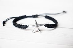 This bracelet has a Starfish silver tone connector, in a zinc alloy metal.  This bracelet is adjustable to ensure a great fit. Many colors to choose from. Photo shown is blue cotton cord.Sizes:Small (5.5 - 6.5 inches)Medium (6.5 - 7.5 inches)Large (7.5 - 8.5 inches)These charms are made from a zinc alloy metal which is lead and nickel free. Measurements: 24mm x 17mm*Avoid getting the bracelet wet to lengthen the life of your bracelet*Please review the listing description and feel free to ask any Silver Starfish Bracelet For Gift, Silver Starfish Bracelet, Adjustable Metal Star Bracelet, Adjustable Star Shaped Metal Bracelets, Adjustable Star-shaped Metal Bracelets, Adjustable Star-shaped Metal Bracelet, Silver Friendship Bracelets With Sliding Knot, Casual Adjustable Star-shaped Jewelry, Adjustable Silver Charm Bracelet With Starfish