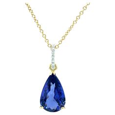 This gorgeous necklace features a fine, 8.90 carat tanzanite with perfect bluish purple color! The pear-shaped tanzanite is set in an 18k yellow gold basket that was custom-made especially for this gem. Brilliant white diamonds have been set in the 18k white gold bail, providing a striking complement to the high-polished yellow gold. Handcrafted by our Master Jewelers in Los Angeles, this necklace is a beautiful example of timeless elegance and sophistication! Pendant measures 1-1/8" in length, Luxury Tanzanite Necklace With Brilliant Cut, Gold Tanzanite Pendant Jewelry, Yellow Gold Tanzanite Pendant Necklace, Classic Tanzanite Pendant Jewelry, Luxury Tanzanite Pendant Necklace, Tanzanite Diamond, Gold Necklace Designs, Yellow Gold Chain, Diamond Pendant Necklace