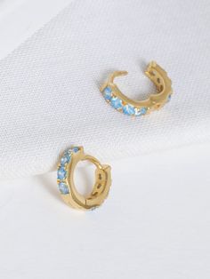 An update to your favorite everyday huggies. The front of these huggie mini hoops is set with sparkling Blue Cubic Zirconia for an eclectic pop of color. Made with 18ct gold vermeil, they're simply striking worn alone, or mixed with other mini hoops, charm and cuff earrings for a perfectly curated ear stack. Measuring 8mm in diameter, making them perfect for 2nd and 3rd hole pericings. Please see the link below to view other items in our range: https://www.etsy.com/uk/shop/12CasaCala PACKAGING These earrings arrive in in our hypoallergenic holographic jewellery pouch.  To make a perfect gift, why not upgrade to a gift box with gift wrapping and a handwritten message card of your choice! CARE INFORMATION These earrings can be worn everyday, store in the protective pouch they were delivered Curated Ear, Jewellery Pouch, Hoops Gold, Ear Stack, Meaningful Jewelry, Blue Quartz, Pearl Gemstone, Jewelry Repair, Cuff Earrings