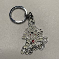 a keychain with an image of a tiger on it's face and the word