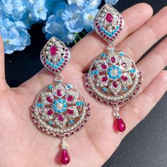 Featuring a pair of statement earrings on pure 925 sterling silver studded with pearls, ruby like red stones and turquoise. The earrings are in silver finish without gold plating done. They close with a bombay screw mechanism Ceremonial Ruby Earrings With Meenakari Detailing, Bohemian Silver Meenakari Jhumkas, Sterling Silver Meenakari Earrings, Red Meenakari Dangle Earrings, 22k Gold Jewelry Necklaces, Ceremonial Ruby Meenakari Earrings, 22k Gold Jewelry, Pearl Necklace Set, Gold Jewelry Necklace