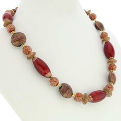 This stunning necklace is a rare Venetian glass treasure with its unique combination of elegant shapes, unique patterns, and deep gorgeous colors. Stylish beads of various shapes intertwine effortlessly and create a tasteful and artful design. The necklace features a mix of gorgeous cranberry and shimmering cocoa colors. The use of avventurina technique adds delicate gold sparkles for an exquisite and timeless look. Hand-blown and designed by Murano glass artists, this versatile piece showcases Oval Glass Gemstone Bead Necklaces, Glass Necklaces With Oval Gemstone Beads, Oval Gemstone Bead Necklaces, Elegant Murano Glass Necklace For Gift, Elegant Murano Glass Necklaces For Gift, Elegant Glass Beaded Necklaces With Oval Beads, Elegant Glass Beaded Necklaces With Natural Stones, Elegant Necklace With Large Czech Glass Beads, Elegant Multicolor Glass Necklaces