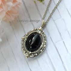 This beautiful locket is adored with Victorian style filigree and a black glass jewel set in the center of the front of the locket.  Size: 24x30mm Chain Lenth: Per Option Finish: Antique Silver Qty: 1pc I also can made this locket necklace with moon stone cabochon, see the second photo Luxury Victorian Pendant Locket Necklace, Luxury Silver Oval Pendant Locket Necklace, Luxury Formal Locket Necklace With Detachable Pendant, Elegant Black Personalized Necklace, Personalized Black Metal Necklaces, Ornate Black Metal Necklace, Vintage Black Oval Pendant Jewelry, Silver Gothic Locket Jewelry, Black Enamel Oval Necklace As Gift