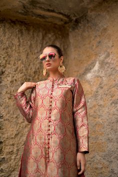 Obaid Sheikh Exclusive CollectionA structured, Mughal-inspired, pure atlas sherwani in a spice red color. Paired with a khadi silk dupatta and hand-embroidered brooch detail. All in all, a truly regal look. Transitional Red Raw Silk Kurta, Traditional Tussar Silk Sherwani With Resham Embroidery, Chanderi Bandhgala With Traditional Drape For Designer Wear, Elegant Chanderi Bandhgala For Transitional Season, Festive Embroidered Tussar Silk Sherwani, Designer Red Raw Silk Kurta, Elegant Chanderi Nehru Jacket With Traditional Drape, Red Raw Silk Kurta With Traditional Drape, Ceremonial Tussar Silk Kurta For Transitional Season