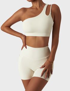 Our athletic fitness set is made from skin-friendly nude fabric for a soft, comfortable fit that's perfect for fitness enthusiasts. The top features an asymmetrical one-shoulder cutout for medium support and comfort. The matching high-waisted shorts and leggings feature a high-waisted design to provide extra shock-absorbing support and a snug fit and come with two exterior pockets on the side large enough to carry small items. Perfect for yoga, pilates, training, and other fitness activities, th Cream Activewear, High Support Bra, Activewear Trends, Pilates Gym, Cute Sports Bra, Estilo Fitness, Athleisure Tops, Yoga Suit, Bodysuit Dress