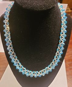 This is a gorgeous aqua blue crystal beaded necklace. It contains 50 large crystals and 50 smaller crystals, all in the same matching aqua color, clear and aqua seed beads and a silvertone lobster claw clasp. This necklace is so pretty and would dress up, or compliment any outfit. It would also make a beautiful gift. This is a one-of-a-kind necklace, as is all of my jewelry. Thank you for looking and happy shopping. Crystal Beaded Necklace, Crystal Bead Necklace, Aqua Color, Large Crystals, Bead Jewellery, Blue Crystals, Aqua Blue, Lobster Claw, Pendant Necklaces