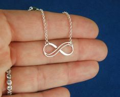 Sterling silver double infinity necklace, infinity knot, infinity symbol, bridal jewelry, sterling silver necklace, eternity necklace A double wire infinity link is attached to a sterling silver chain that can be any length up to 22 inches in length and is secured with a sterling silver lobster claw clasp. You can choose between the small, medium, and large infinity links. The small infinity measures 0.55 x 0.26 inches (14 x 6.5mm). The medium infinity measures 0.79 x 0.37 inches (20 x 9.5mm). T Sterling Silver Infinity Necklace With Adjustable Chain, Silver Infinity Necklace In Dainty Style, Silver Infinity Dainty Necklace, Silver Dainty Infinity Necklace, Silver Infinity Jewelry, Dainty Silver Infinity Necklace, Silver Infinity Jewelry With Adjustable Chain, Simple Silver Jewelry For Bridesmaid Gift, Silver Infinity Necklace With Delicate Chain