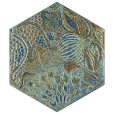 an intricately designed blue and green area rug in the shape of a hexagonal object