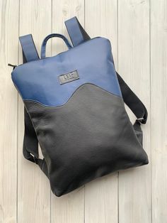 "Blue Leather Backpack, One Of A Kind Backpack Up-cycled blue leather backpack. Unique and one of a kind, you won't find anyone with the same backpack. Zip it and you will find natural lining with open and zipped pocket inside. LeaF leather backpacks are very light and not overloads your back.  Minimalist design leather backpack fits 15\" laptop. Size - 32x42 cm You can choose backpack plus leather purse. Pouch is perfect for your cosmetics, laptop charger or to use it as evening bag. It is made Modern Blue Leather Backpack For Everyday, Modern Everyday Blue Leather Backpack, Blue Leather Backpack For Everyday Use, Blue Tote Backpack With Removable Pouch, Blue Rectangular Backpack With Adjustable Strap, Blue Backpack For Everyday Use, Blue Satchel Leather Backpack For On-the-go, Blue Leather Satchel Backpack For On-the-go, Modern Blue Leather Backpack For Travel