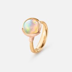 a gold ring with an opal stone in the center and a white, yellow or red