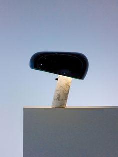 a light that is sitting on top of a white block with a sky in the background