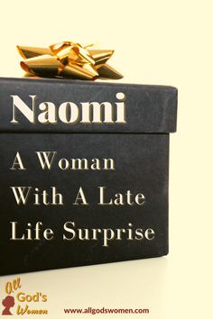 a woman with a late life surprise is wrapped in black paper and gold bows on top