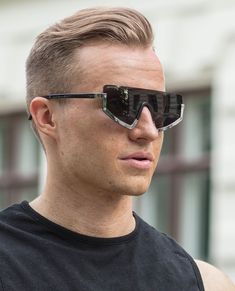 These noticeable sunglasses are an interpretation of the sporty shield shape, destined to enrich the urban buzz of the city life. The frame of the glasses is made of contrasting materials and clings only to the lower part of the lenses, while leaving the eyebrow area free. It's accompanied by fine, low-set temples. The stylish accessory is made of polycarbonate, zinc alloy and copper. The sunglasses are being delivered together with a protective pouch with Urban Classics logo and drawstring clos Sunglasses Silver, Gold Sunglasses, The Urban, Santa Maria, City Life, Square Sunglasses Men, Stylish Accessories, Zinc Alloy, New Product