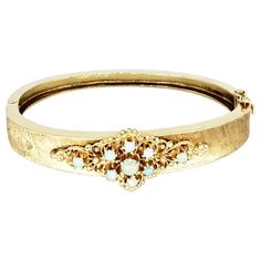 For Sale on 1stDibs - Vintage 10mm Opal Floral Bangle 14k Gold. The bangle measures 2”x2.5” and weights 18.6 grams 14k gold. Heirloom 14k Gold Bangle With 17 Jewels, 14k Stamped Gold Bangle For Wedding, Wedding Gold Bangle Bracelet Stamped 14k, 14k Gold Bangle Bracelet For Wedding, 14k Gold Hinged Bangle For Wedding, Gold Hinged Bangle Bracelet For Wedding, The Bangles, Vintage Bangles, Color Champagne