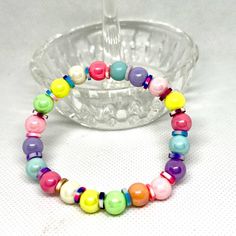 Add a pop of color to your outfit with this handmade fashion colorful bead bracelet. The vibrant combination of colors along with polymer clay spacer beads will surely catch the eye and elevate your style. Perfect for adding a touch of sophistication to any ensemble, this bracelet is versatile and easy to wear. Whether you're dressing up for a special occasion or just looking to add some fun to your everyday look, this bracelet is the perfect accessory. Handcrafted with care, this bracelet is a unique piece that you'll love to show off. Handmade Colorful Vibrant Beaded Bracelets, Playful Multicolor Beaded Stretch Bracelet, Novelty Stretch Bracelet With Colorful Beads, Novelty Bracelets With Colorful Beads, Multicolor Novelty Stretch Bracelet With Colorful Beads, Colorful Bead Bracelets, Handmade Fashion, Spacer Beads, Unique Pieces