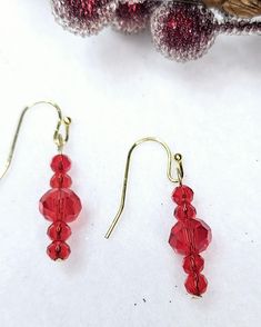 Handcrafted Red Faceted Glass dangle drop earrings. They are the perfect earrings for any occasion. They pair well with any casual outfit and make a great gift for family and friends--Red Faceted glass. Perfect for a Christmas gift or gift for her. Beautiful deep green finish. SHIPPING:  PROCESSING TIME IS CURRENTLY 1-2 DAYS FROM THE DATE OF PURCHASE. Processing time does not include shipping which is an extra 3-5 days. You will receive an email with tracking information once your order ships. O Red Crystal Drop Earrings For Gifts, Red Dangle Crystal Earrings For Gift, Red Dangle Crystal Earrings As A Gift, Red Ear Wire Earrings For Holiday, Red Ear Wire Jewelry For Holidays, Holiday Red Ear Wire Earrings, Red Holiday Earrings With Ear Wire, Elegant Red Beaded Earrings For Christmas, Red Beaded Drop Earrings For Christmas