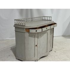 an antique desk with two drawers and a tray on the top, in white painted wood