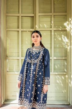 Pakistani Blue Dress in Frock Trouser Style for Eid is a traditional masterpiece to have a charismatic appearance on the festive occasion. This stunning Frock and Churidar is adorned with lavish designs and embroidery, making this attire your foremost priority to have a head-turning appearance. Frock: The beautiful Pakistani Frock in an alluring blue shade comes in premium cotton fabric. The beautifully stitched Pakistani Blue Dress is adorned with graceful embroidery work and threads. Floral de Chanderi Floral Embroidered Dress For Eid, Designer Dresses With Floral Embroidery For Eid, Designer Chanderi Dress With Floral Embroidery, Blue Floral Embroidered Kurta For Reception, Blue Floral Embroidery Kurta For Reception, Silk Dresses With Floral Embroidery For Navratri, Blue Raw Silk Salwar Kameez With Mirror Work, Raw Silk Straight Kurta Dress With Floral Embroidery, Blue Silk Dress For Navratri