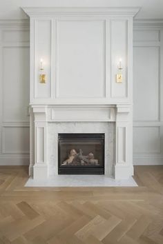 an empty room with a fireplace and white walls