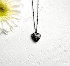 "Teeny Tiny Locket Necklace, Black Heart Locket Necklace A tiny black heart locket hangs from a black chain. Please select a length from the drop-down box.   The locket measures 1/2\" x 1/2\".  *We do not personalize nor insert pictures. The locket and chain are black nickel plated over brass, so it's recommended removing before showering, swimming, etc. to keep jewelry looking like new. Black Heart Locket Necklace Engraved Two Hearts https://www.etsy.com/listing/1367121574/black-heart-locket-ne Black Heart Necklaces For Keepsake, Black Heart-shaped Necklace For Keepsake, Black Heart Necklace For Keepsake, Black Locket Necklace For Gift, Black Heart Necklace With Adjustable Chain As Gift, Vintage Black Locket Necklace Gift, Tiny Locket, Black Locket, Gold Heart Locket