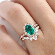 This large oval emerald ring bridal set features a vintage-inspired emerald engagement ring set in a 14k rose gold vintage floral halo diamond ring setting. To complete the unique vintage style look, a large 7 diamond U-shaped scalloped wedding band is created to pair with this oval emerald diamond ring. Celebrate your love with this beautiful earthy green engagement ring set! It can be crafted in your choice of platinum, or 18k or 14k yellow, rose, or white gold. ** The hand model's ring size i Engagement Rings Emerald Green, Oval Ring Set, Oval Emerald Ring, Green Engagement Rings, Emerald Engagement Ring Set, Diamond Alternative Engagement Ring, Black Diamond Studs, Vintage Halo, Halo Diamond Earrings