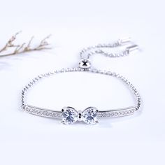 Shimmering with your affection, this bracelet shoots straight to her heart. Crafted in sterling silver, this charming design features a sparkling bowknot and shimmering round stones across the center. Elegant and feminine, this stylish bracelet is a feminine look she'll love. Carat Weight: 1.71 ctStone Size: 7*7,1.5 mmNumber of Stones: 22 Stone Shape: Heart, RoundStone Color: Diamond WhiteMaterial: 925 SilverPlating Color: Silver Adjustable Heart Bracelet For Formal Occasions, Luxury Silver Bracelets For Valentine's Day, Luxury Heart Bracelet As A Gift, Elegant White Gold Chain Bracelet For Valentine's Day, Luxury Adjustable Heart Bracelet, Valentine's Day Gift Elegant Chain Bracelet, Adjustable White Gold Heart Bracelet, Elegant Heart Bangle Bracelet For Valentine's Day, Elegant Silver Heart Bracelet As Gift