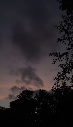 the sky is very dark and cloudy at night, with some clouds in the distance