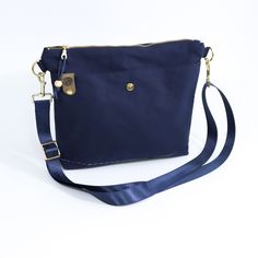 Discover the Navy Oilskin Hobo Bag, perfect for those who need extra space without compromising on style. This hobo bag is ideal for carrying all your essentials with ease. Its roomy interior and chic design make it a must-have for any wardrobe. Don't miss out—add this versatile and stylish hobo bag to your collection today. Chic Design, Hobo Bag, Navy