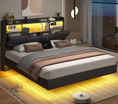 a bedroom with a bed that has lights on the headboard and night stands next to it