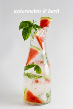 a watermelon and mint drink in a glass pitcher