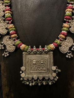 Get lost in the detail and unique beauty of antique silver Banjara beads strung onto a beautifully woven cord, handcrafted in India. All of our jewelry is one of a kind, handmade, and fair trade. A truly one of a kind piece, this necklace features the breathtaking intricacy of century old Banjara silverwork which is gracefully contrasted by the colorful and intricate woven cord they’re strung upon. The Banjara are one of the ancient nomadic tribes in India and have been known for centuries for t September Style, Tribes In India, Silversmithing Jewelry, Fabric Jewellery, Silver Bag, Antique Gold Jewelry Indian, Antique Jewellery Designs, Round Bead Necklace, Afghan Fashion