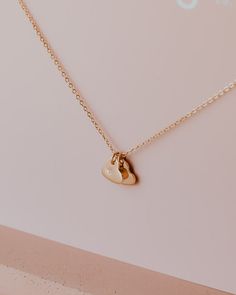 Initial Hearts Necklace Show some love with our Initial Hearts necklace. Perfect for wearing alone or stacking with our other Every Day Collective Co. necklaces and chokers. Made in both 14k Gold Fill or Sterling Silver. To find your perfect length, we suggest using a ruler and a piece of string that hangs naturally like a necklace to determine your desired length. Please indicate your initials of choice in the box above! One initial will be stamped per heart. Minimalist Everyday Charm Necklace With Heart Charm, Minimalist Everyday Charm Necklace With Heart, Minimalist Everyday Necklace With Heart Charm, Dainty Everyday Heart Charm Necklace, Minimalist Tiny Necklaces For Valentine's Day, Minimalist Heart Charm Jewelry For Everyday, Minimalist 14k Gold-filled Jewelry With Heart Charm, 14k Gold-filled Heart Necklace With Heart Charm, Minimalist Everyday Jewelry With Heart Charm