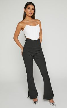 Step up your style game with our Beau Pants. These high-waisted, full-length skinny leg pants are the perfect addition to your casual wardrobe. Made from a comfortable and lightweight rayon fabric, these black pants will effortlessly elevate any outfit. The split hem adds a trendy touch while allowing for easy movement. Whether you're heading to brunch or a night out with friends, these versatile Beau Pants have got you covered. Embrace your individuality and show off your fierce fashion sense i High Waist Yoga Pants With 4-way Stretch For Spring, Black Wide Leg 4-way Stretch Leggings, Black Wide Leg Leggings With 4-way Stretch, Chic Elastane Yoga Pants For Loungewear, Ankle-length Stretch Yoga Pants, High-waisted Elastane Pants For Loungewear, High Stretch Black Pants, High Waist Athleisure Leggings For Work, Chic 4-way Stretch Bottoms For Loungewear