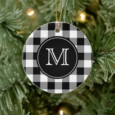 a black and white ornament hanging from a christmas tree