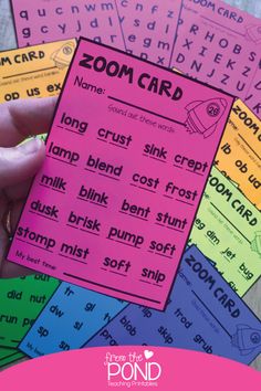 someone is holding up some pink and blue cards with words on them that spell out the word zoom card