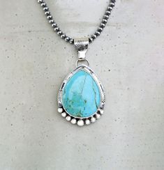 Kingman Sky Blue Turquoise Sterling Silver Necklace on your choice of chain. The setting is a chunky teardrop stone that is 27mm x 22mm and in a Bezel setting. The 925 Sterling Silver has been lightly oxidized.  Your choice of an 18" 3mm Navajo Pearls or 18" Silver Chain with Lobster clasp This cool necklace features a chunky, pear shaped turquoise gemstone with a detailed setting. The soothing hue of the turquoise brings out a southwest style vibe, while the silver accents add a touch of elegan Blue Turquoise Necklace With Large Teardrop Stone, Turquoise Drop Necklace For Jewelry Making, Unique Blue Teardrop Turquoise Necklace, Bohemian Teardrop Large Stone Necklace, Handmade Turquoise Drop Necklaces, Handmade Southwestern Necklace With Teardrop Pendant, Handmade Turquoise Drop Necklace, Artisan Blue Turquoise Teardrop Pendant Necklace, Turquoise Teardrop Pendant Jewelry