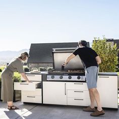 two people are cooking on an outdoor grill