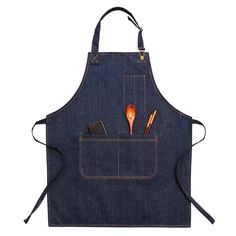 a denim apron with utensils in the pocket and an orange spoon sticking out of it