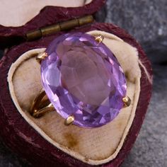 This classic cocktail ring is centered with an elegant oval cut amethyst. The chunky gem is held aloft by a split shoulders setting with a light patina. The ring is crafted in 14k yellow gold is currently a size 5.25. Antique Cocktail Ring, Amethyst Cocktail Ring, Amethyst And Diamond Ring, Bold Rings, Classic Cocktail, Vintage Cameo, Violet Purple, Amethyst Cluster, Classic Cocktails